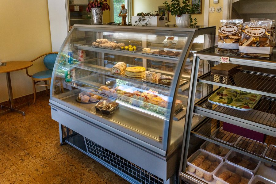 Fresh cakes and pastries displayed in the bakery counter at Isht Bakers & Restaurant